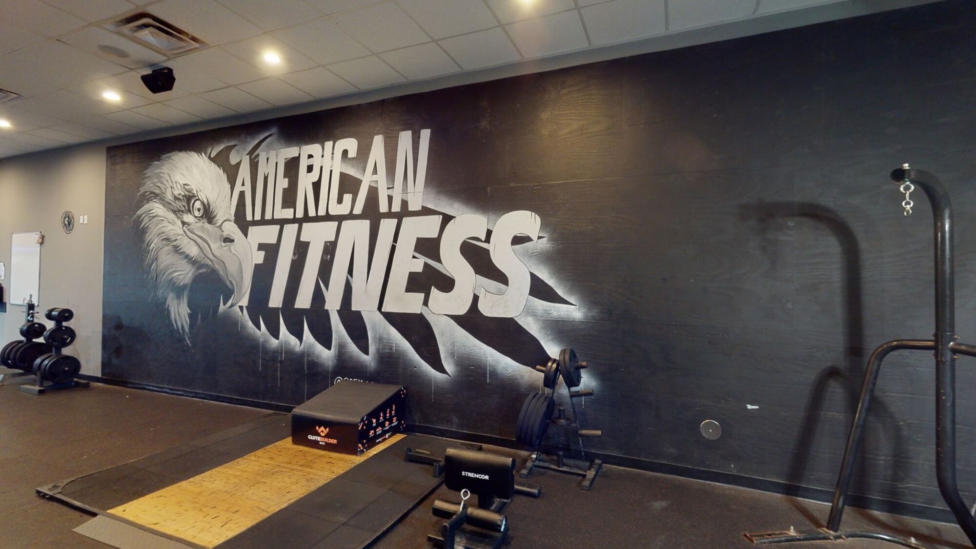 Heavy-lifters room with American Fitness eagle mural