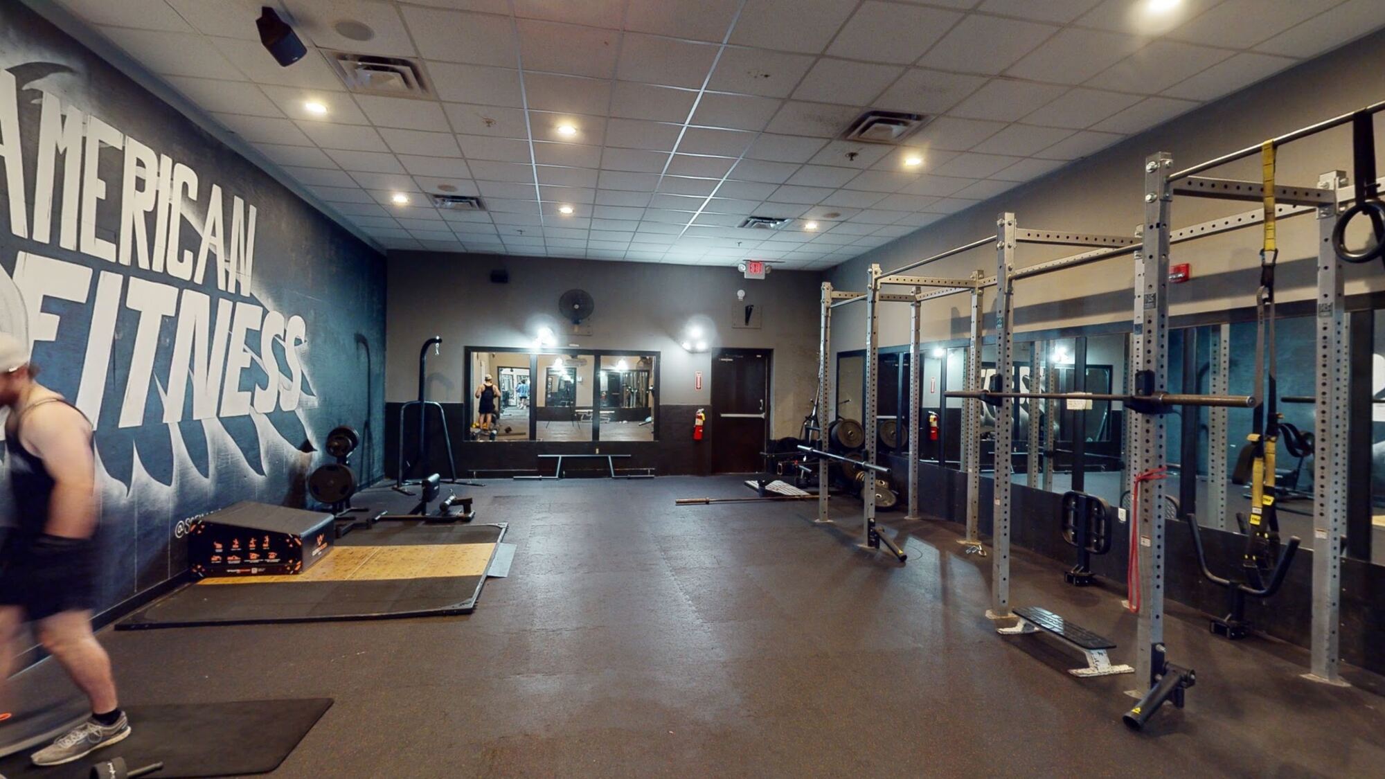 Heavy-lifters room with the American Fitness mural and squat racks